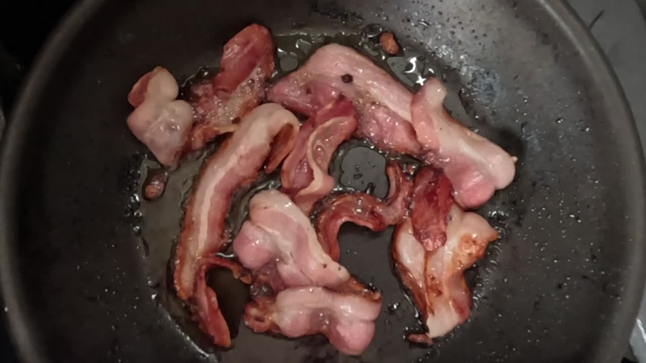 Sequential cooking stages of bacon strips in a skillet