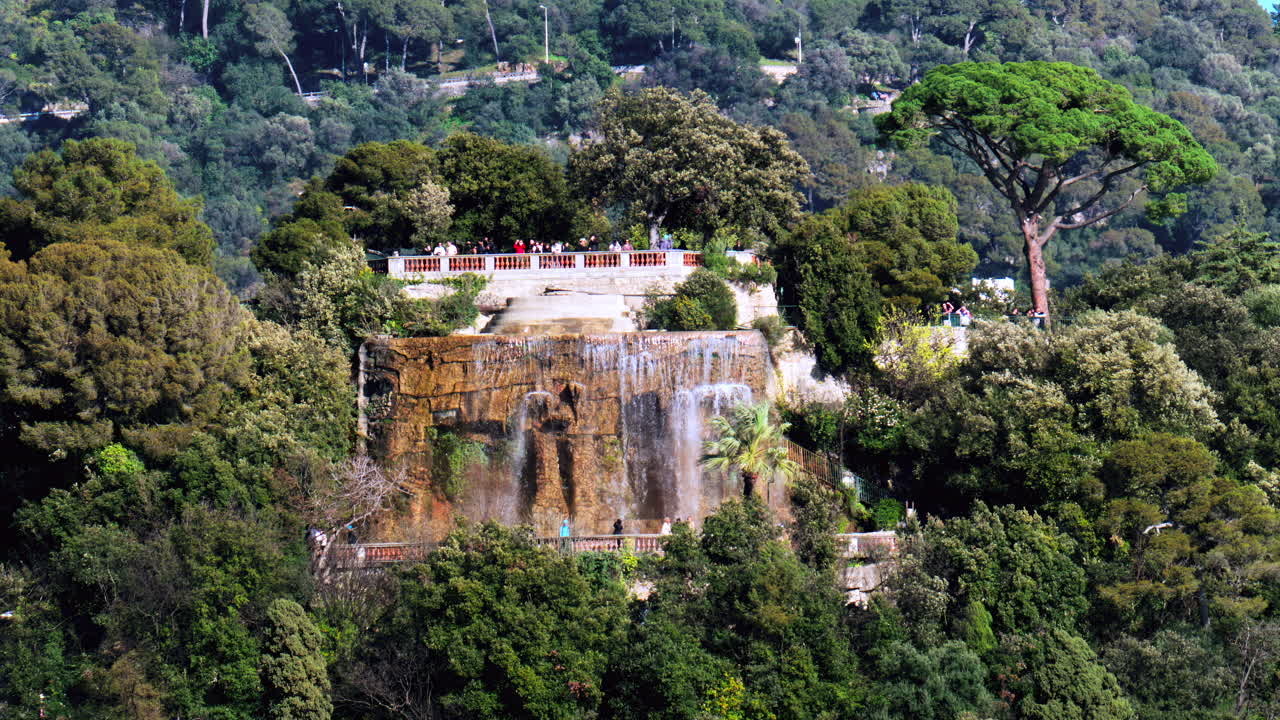 Nice, France - March 17, 2025: Distant view of the Cascade du Chateau on the Chateau hill in daylight