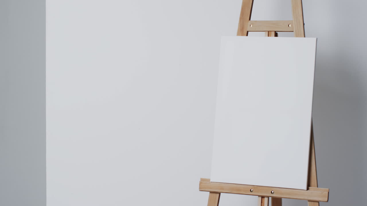 Video of white canvas sign on wooden easel with copy space on white background