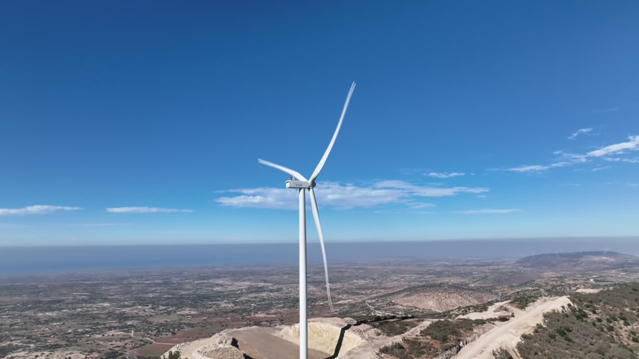 Aerial drone footage capturing the wind turbine in action, converting wind into clean energy