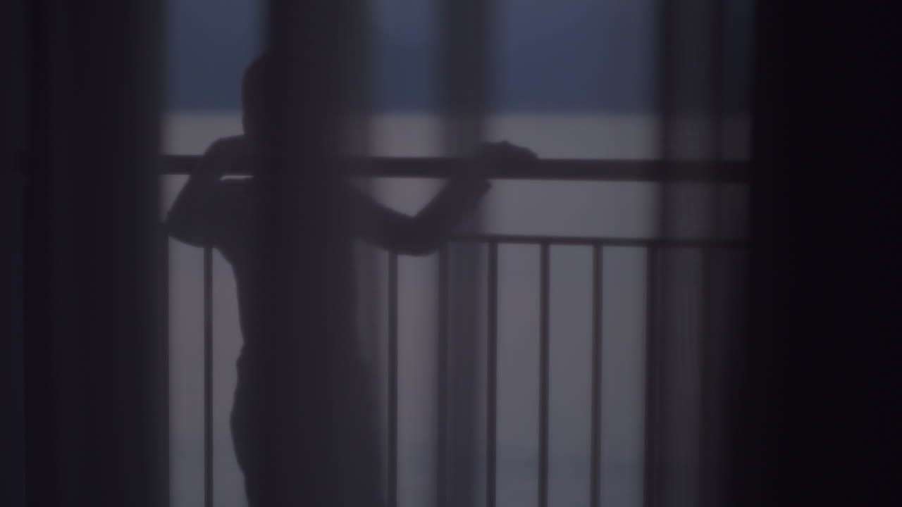 Child looking at the sea from balcony