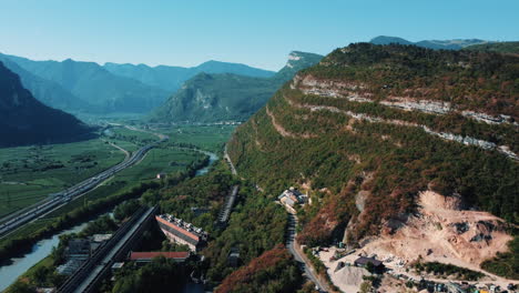 alpine valley landscape with highway and industry