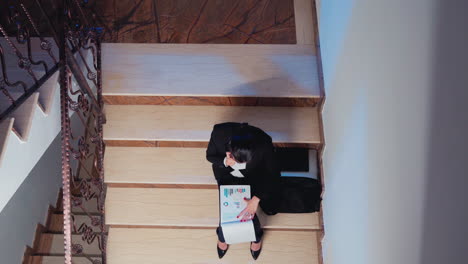 Top-view-of-overworked-businesswoman-talking-on-phone