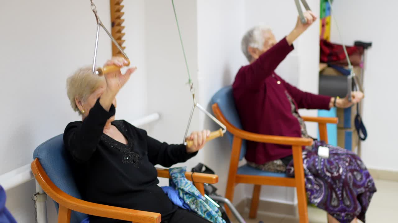 Elderly Women Exercising with Therapy Equipment