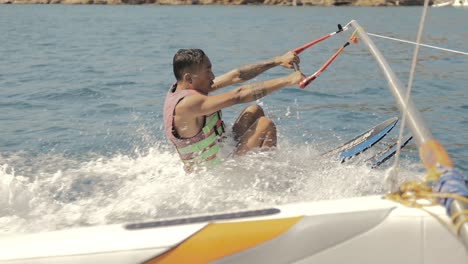 young man learning to waterski