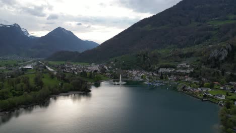 Aerial-view-of-mesmerizing-fountain-display-with-Weesen-Swiss-backdrop