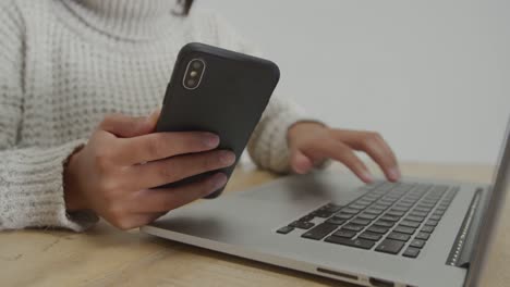 woman using laptop and smartphone