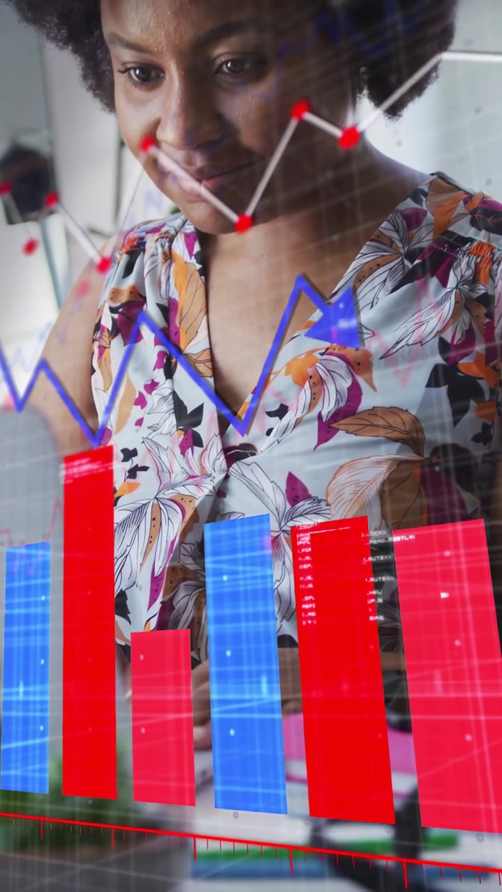 Vertical video: Businesswoman typing at desk, generating red or blue charts over laptop for insights