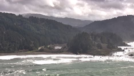 Discover-the-hidden-beauty-of-the-California-coast-with-this-aerial-push-shot-into-a-serene-inlet,-showcasing-crystal-clear-waters,-rugged-cliffs,-and-stunning-natural-landscapes