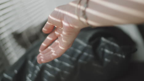 hand of woman near window at home