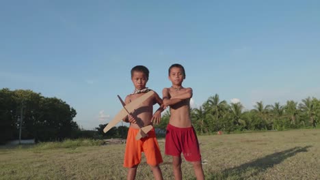 two boys playing with a cardboard airplane