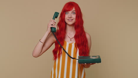 Cheerful-red-hair-girl-secretary-talking-on-wired-vintage-telephone-of-80s,-say-hey-you-call-me-back