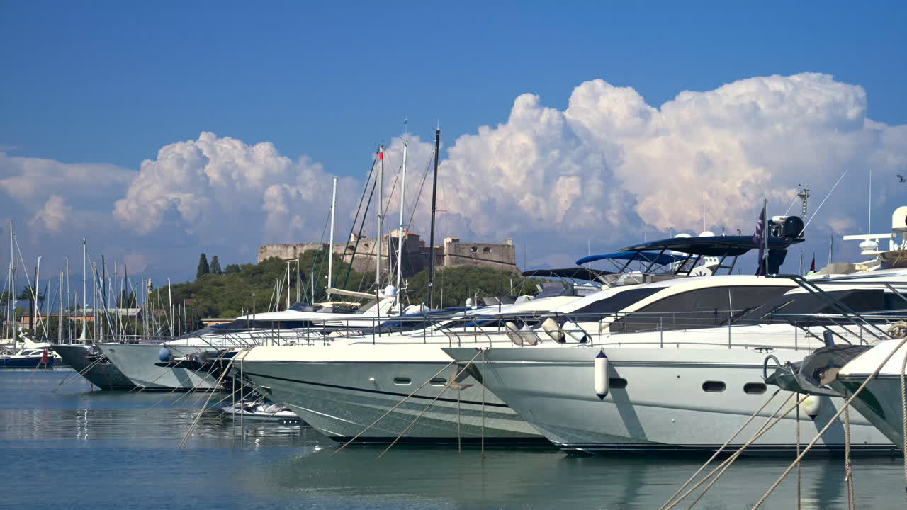 Boats docked in the Port Vauban with the Fort Carre on the background in Antibes, France