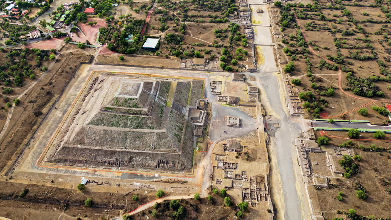 Aerial drone view of the ancient Teotihuacan pyramids with the surrounding Mexican town and mountain landscape