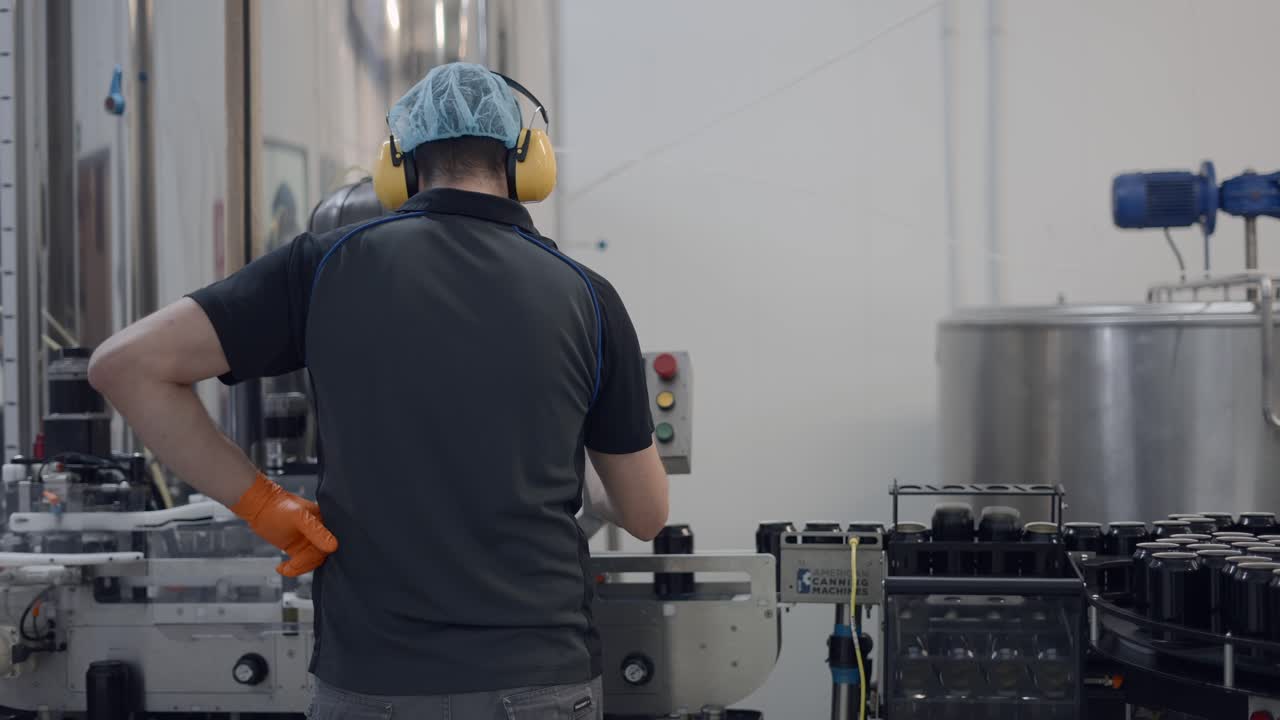 Worker in a beverage canning factory