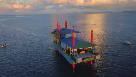 aerial flight at stunning sunset over oil platform in ocean in mabul, malaysia