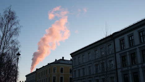 smoke rising from the chimney of a building in oslo, norway