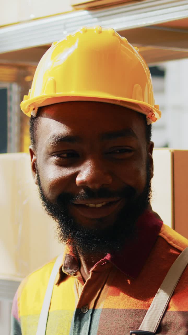 Vertical video: Young person looking at tablet in warehouse space