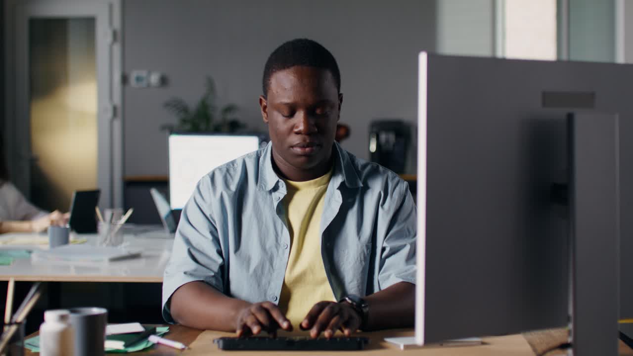 Man Working on Computer in Modern Office