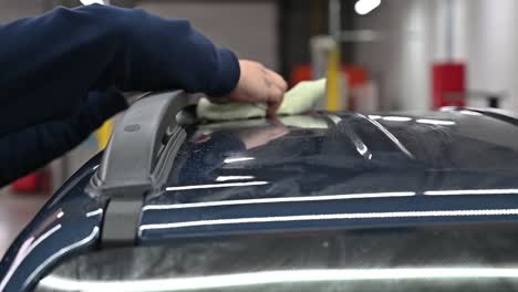man cleaning car roof