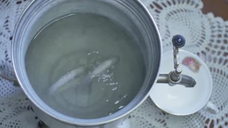 uncovered water heating there starts to heat in a vintage electric metal kettle