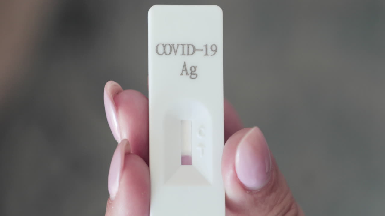 Holding Rapid Swab Test Kit And Waiting For Result For COVID-19 Detection