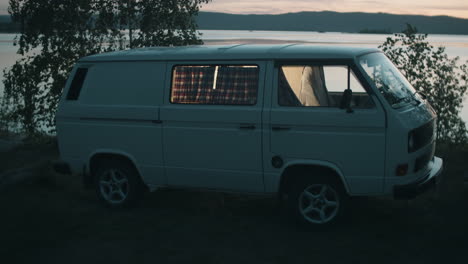 woman camping in van by lake