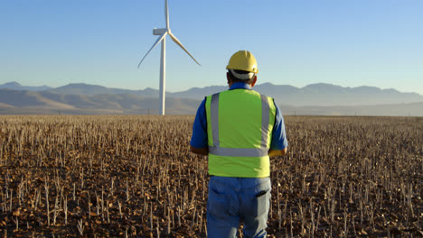 male engineer walking in the wind farm 4k