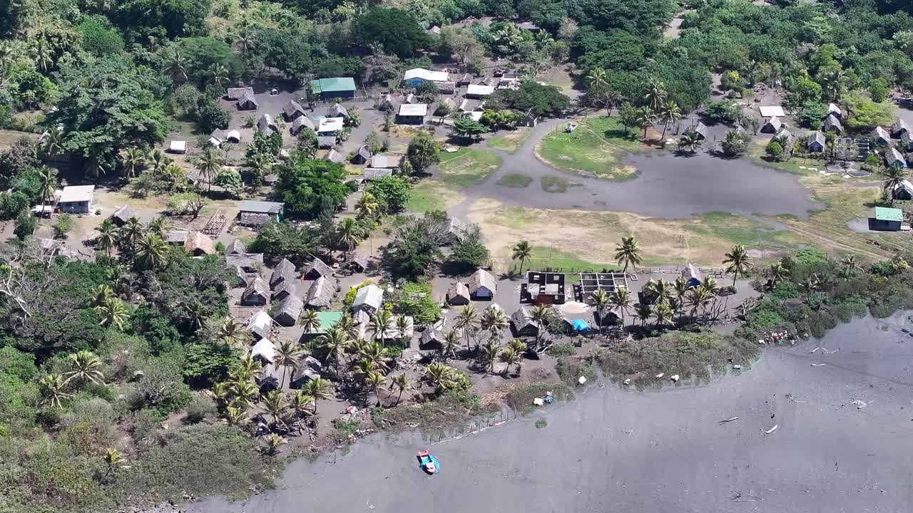 Ipikil remote traditional Vanuatu village in Tanna Island by black sand beach. Drone