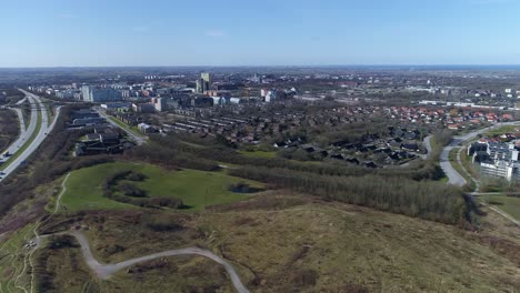 Aerial-push-in-from-e22-highway-toward-ideon,-with-lund-and-öresund-in-background