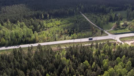 aerial view of a road and railway running through a forest
