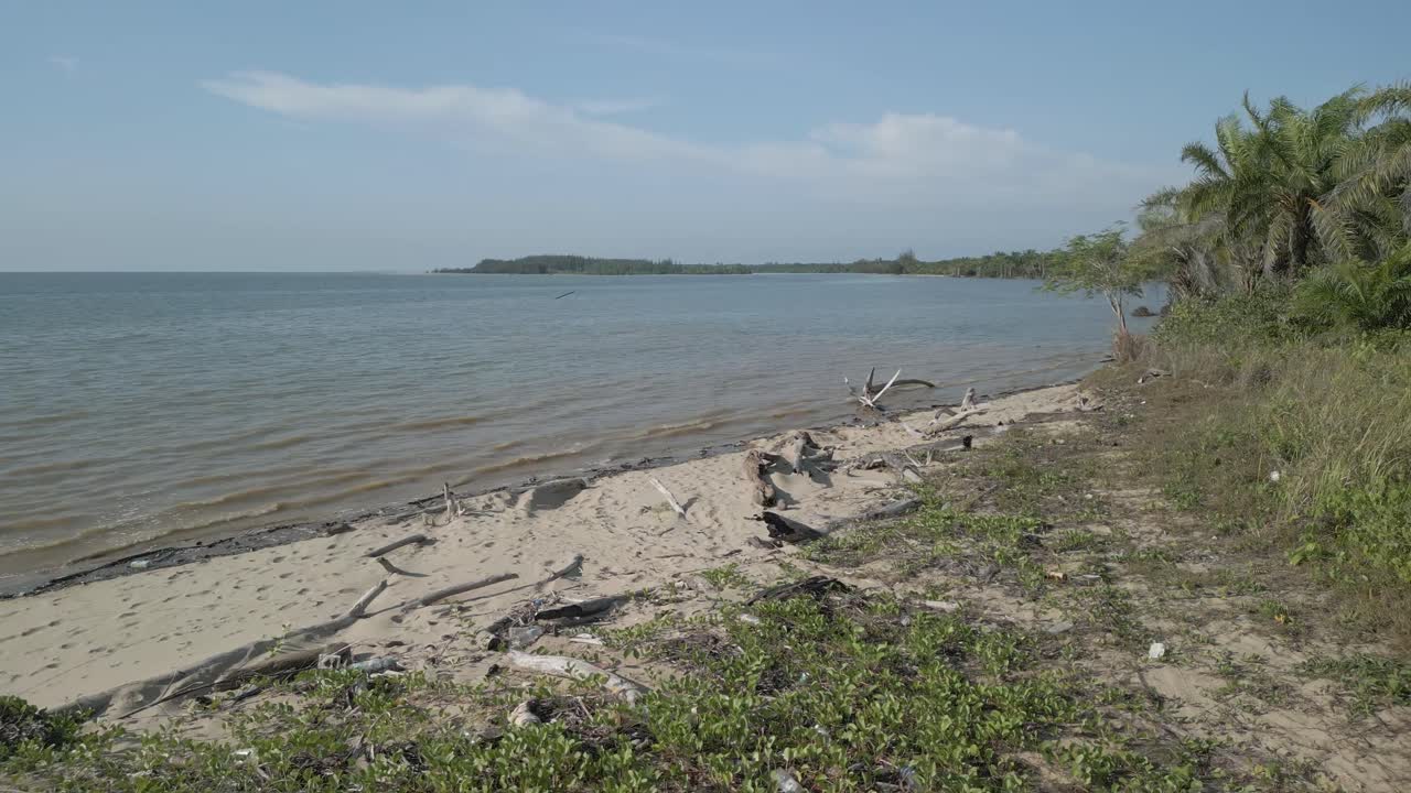 Aerial Drone View During Summer Alit Fishing Village,Kabong With, Facing Open Blue Sea, White Sandy Beach,Green Coconut, Palm Trees,And River,Sarawak,Borneo