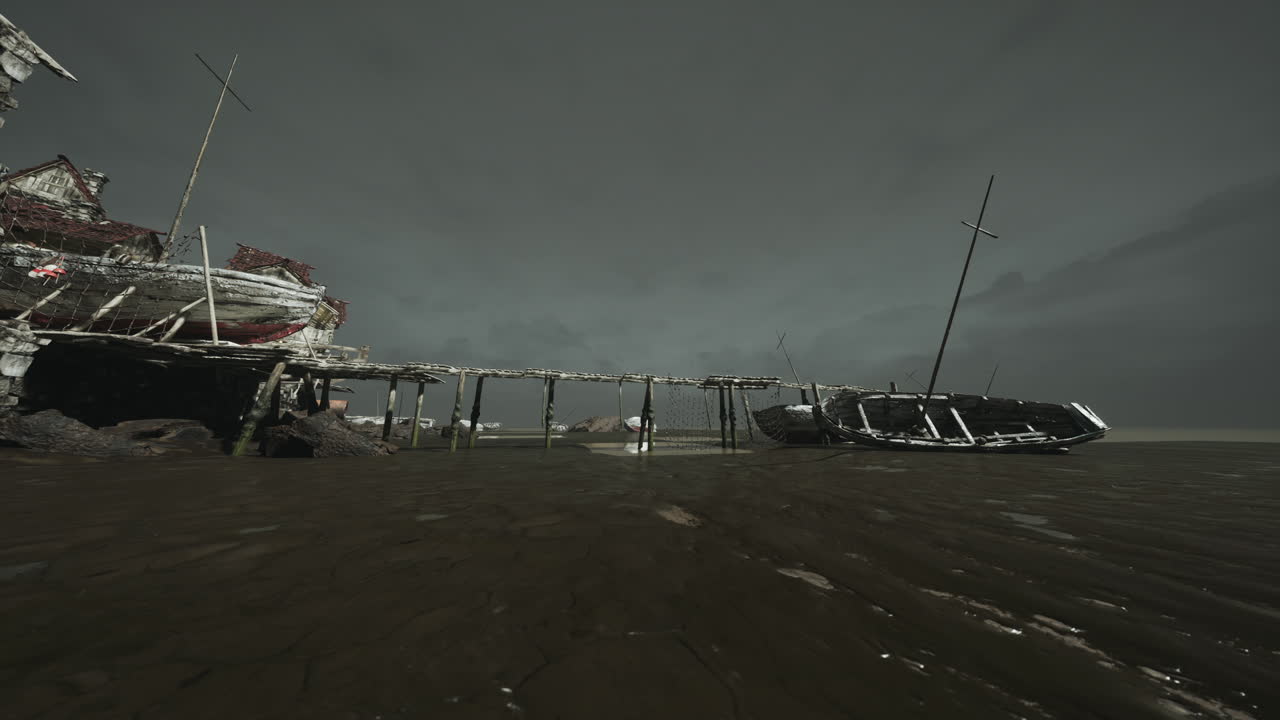 Abandoned boat at low tide near a weathered pier in a coastal area