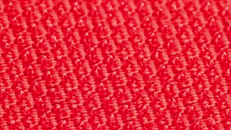 close-up macro view of red velcro surface with micro hooks