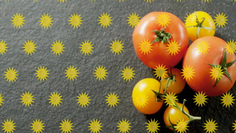 animación de formas de estrellas amarillas sobre tomates en una superficie de textura oscura