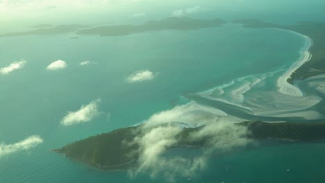 breathtaking golden hour sunlight at whitehaven beach, view from airplane