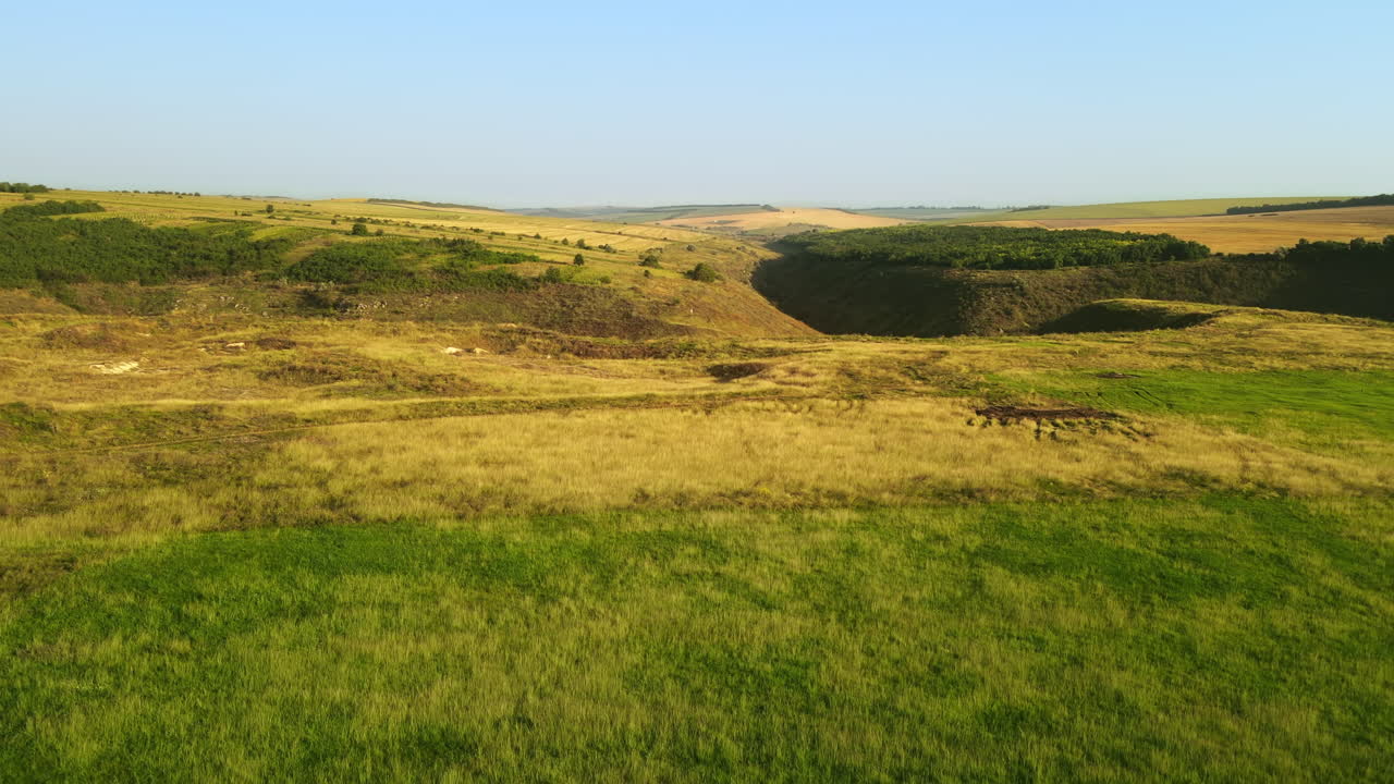 Aerial drone view of nature in Moldova. Valley with green hill slopes, fields