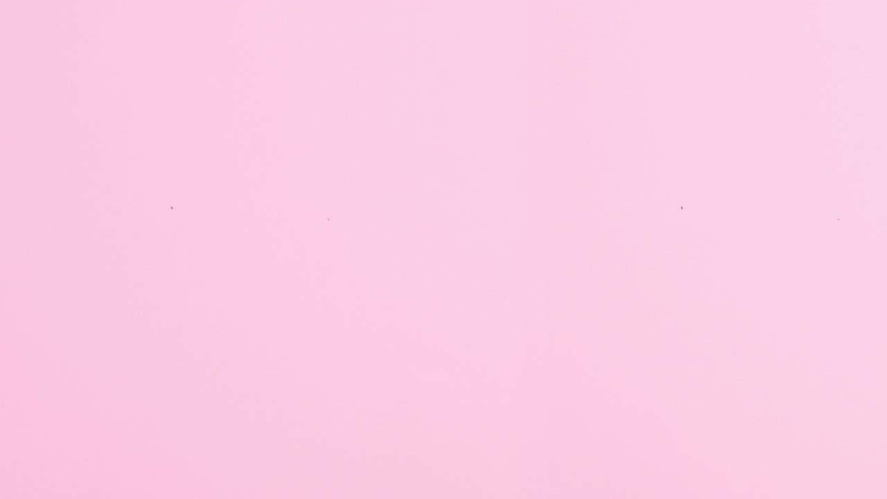 Lipsticks appear on pastel pink theme. Stop motion