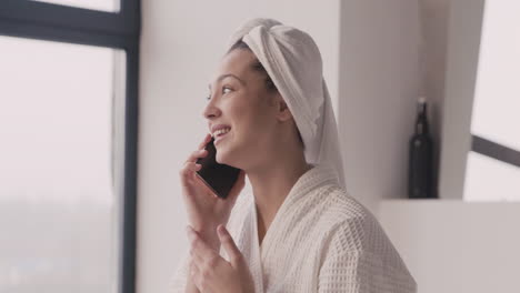 woman in bathrope with a towel in her head talking on the phone 1