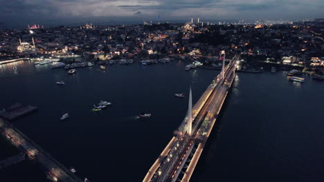 Epic-blue-hour-shot-at-night,-evening-with-the-golden-horn-bridge,-Haliç-Köprüsü,-pan-shot,-Istanbul,-the-metro-with-Masjid-Sultan-Fatih-Mosque,-slow-motion-and-copy-space