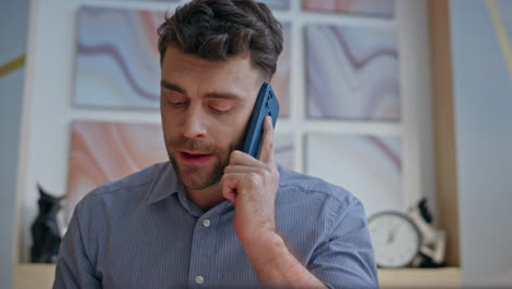 nervous manager calling mobile phone gesturing emotionally at office closeup