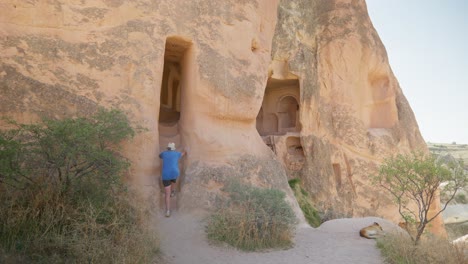 female hiker explores rock cave homes red valley trail cappadoccia