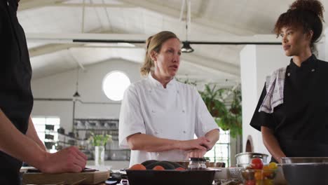 caucasian female chef teaching diverse group