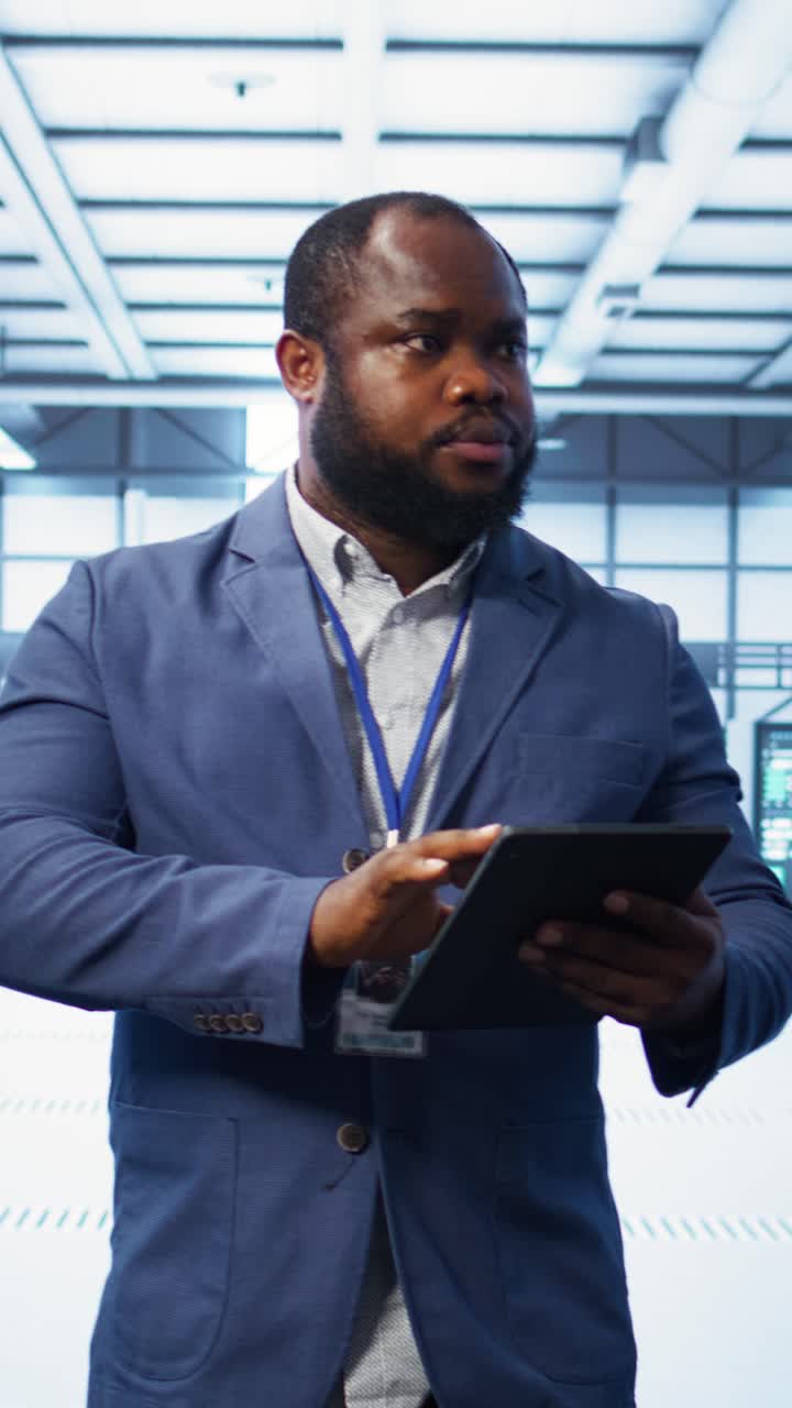 IT Professional Using Tablet in Modern Data Center