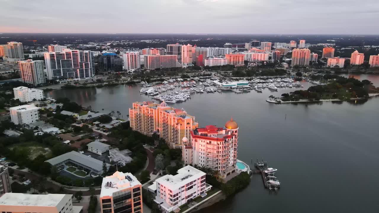 Skyline drone footage of beautiful Sarasota, Florida during sunset. This footage captures the bay area of Sarasota and shows Golden Gate Point and the Marina. 60 fps.