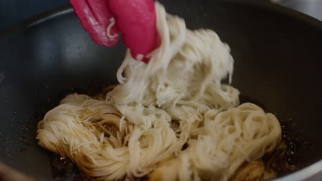 close-up-of-cocking-chinese-noodle-in-a-pan-asiatic-traditional-food