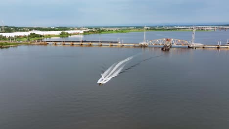 Approaching-aerial-view-of-the-old-River-Draw-Bridge-in-Perth-Amboy,-NJ-with-boat