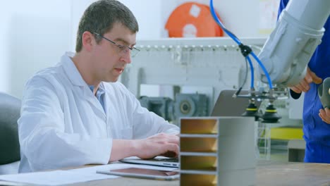 robotic engineers examine robotic machine in warehouse 4k