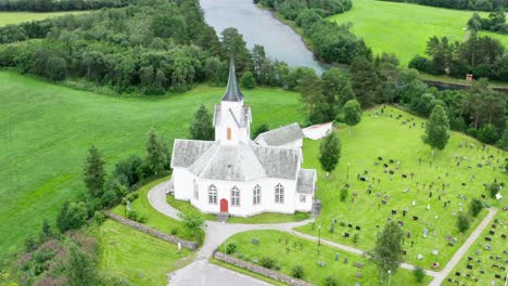 magnificent rotating view of old structure of the katthammaren chapel in norway - aerial shot