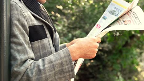 businessman reading newspaper in garden 1